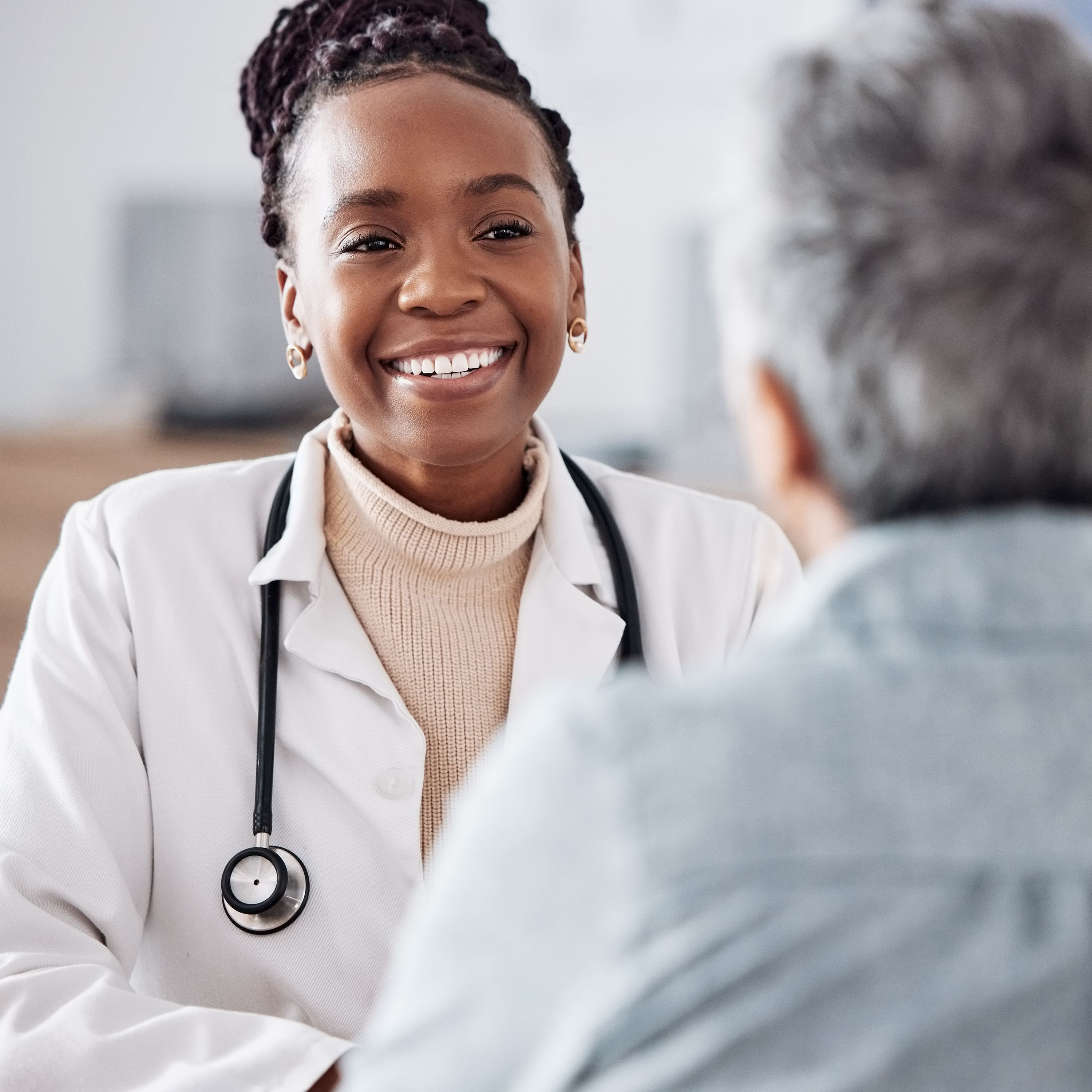 Photo of an elderly person talking with a doctor at a clinic