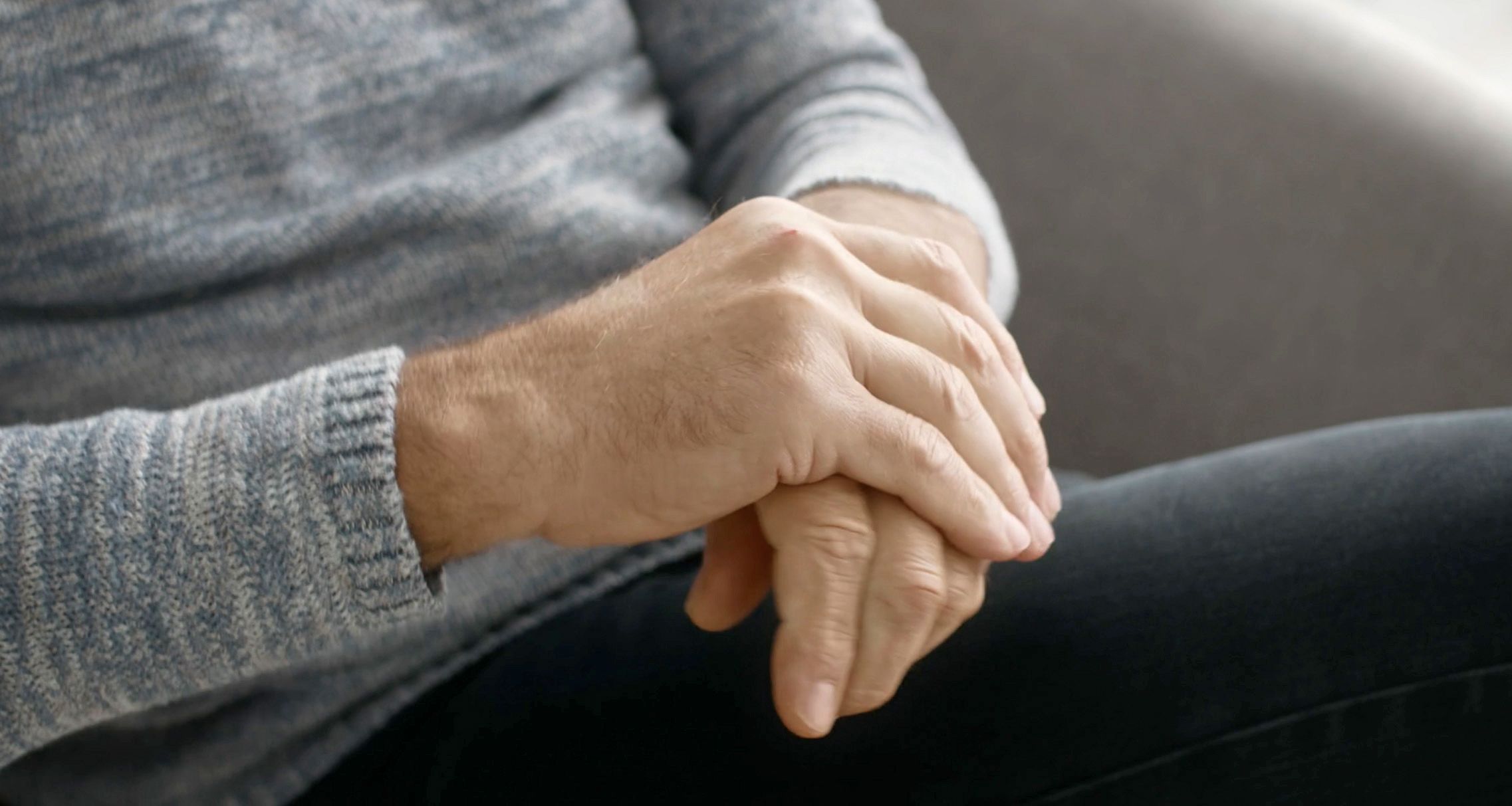 Photo of an elderly person rubbing their hands together