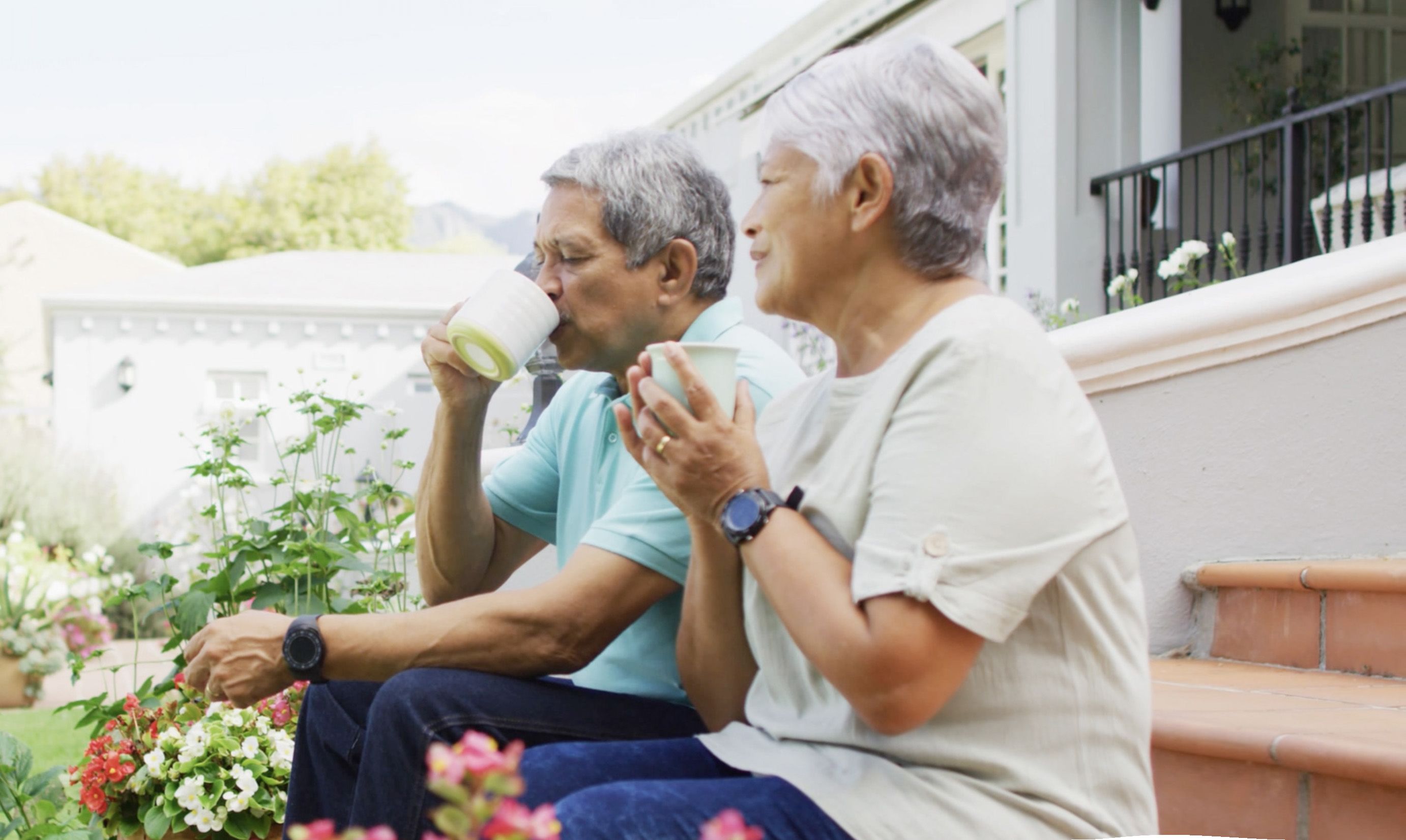 Photo of a man and woman enjoying cups of coffee together