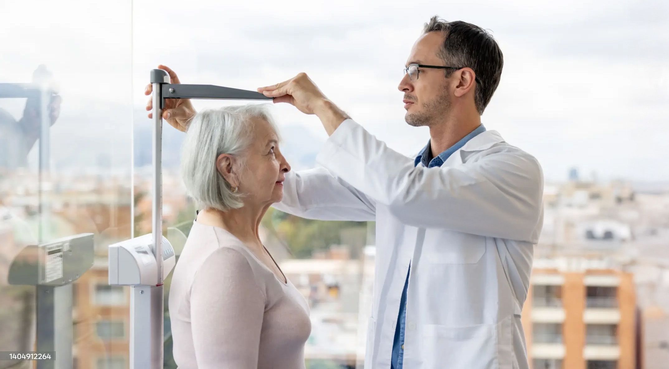 Photo of a doctor measuring a woman's height