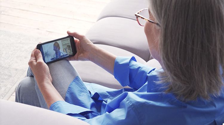 Photo of a woman at home have a virtual consultation with a doctor on her phone